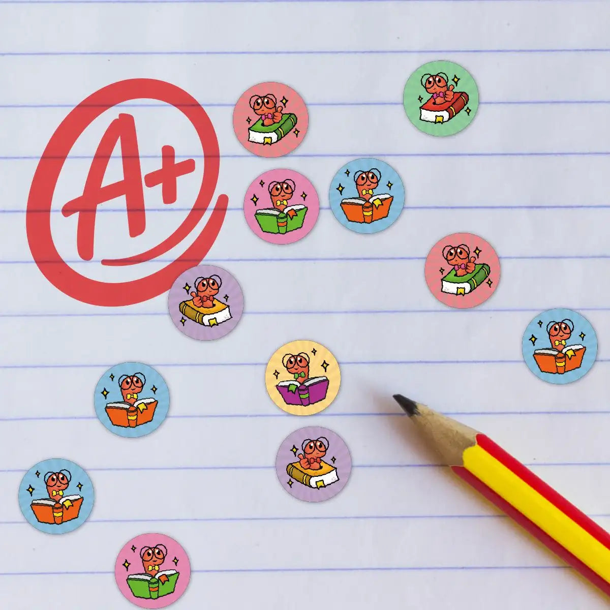 Colorful reward stickers with cartoon bookworm on lined paper, large A+ and pencil nearby