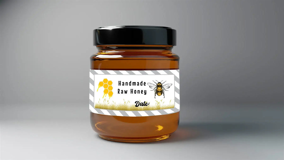 Brown glass jar with label reading Handmade Raw Honey, featuring bee and honeycomb graphics