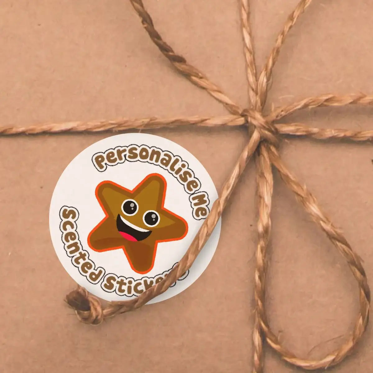 Personalised brown star scented sticker with smiley face on wrapped gift, twine bow.