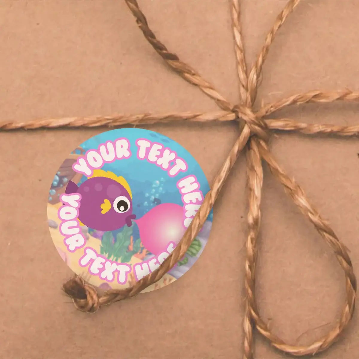 Colorful custom fish reward sticker with underwater theme on brown gift box with twine