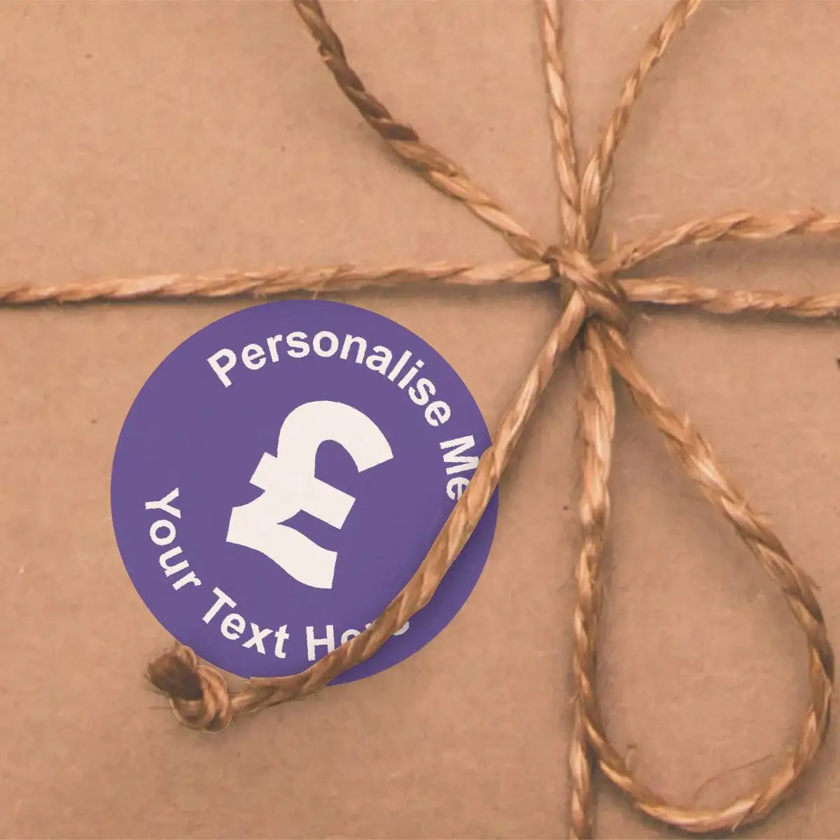 Purple personalised sticker with pound sign on brown gift box tied with twine