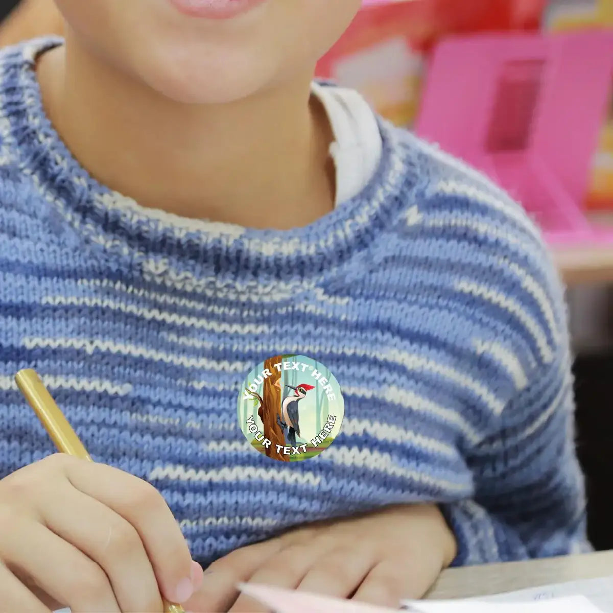Child wearing custom reward sticker with woodpecker design in classroom setting