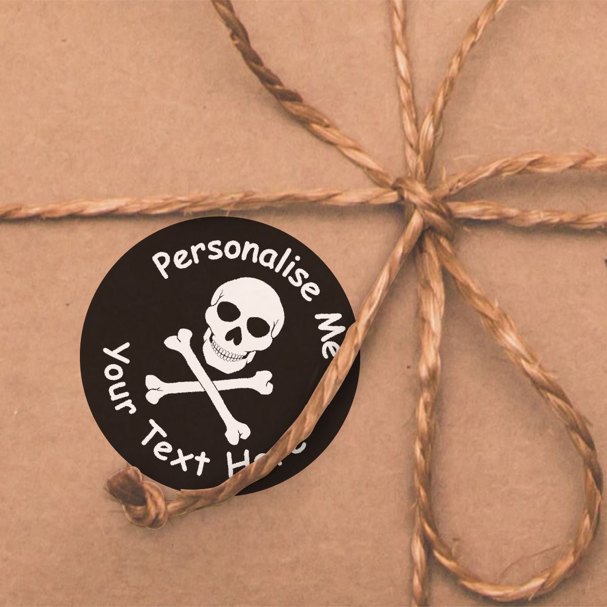 Personalised skull and crossbones sticker on brown gift box with twine bow