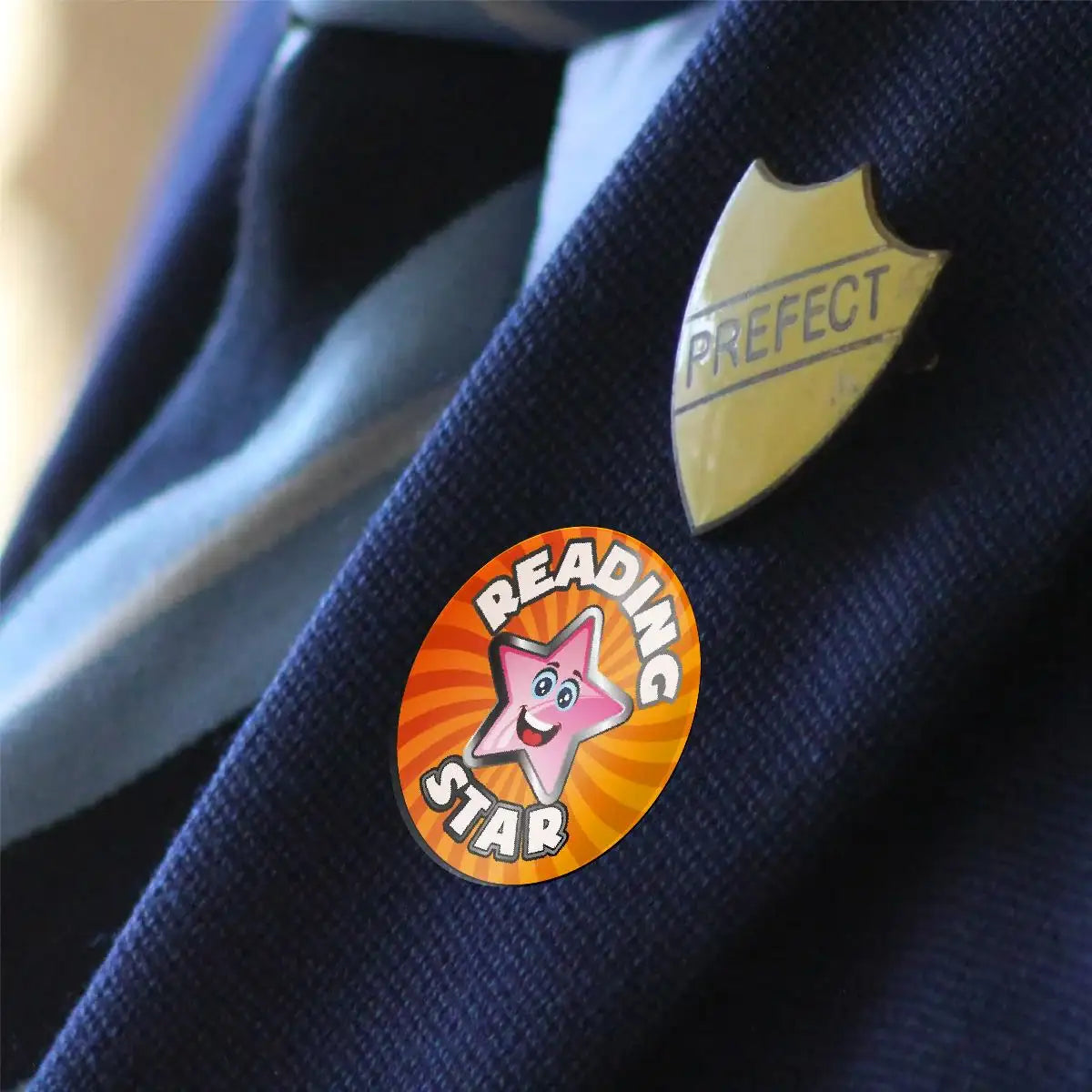 Reading Star reward sticker and Prefect badge on a blue school blazer