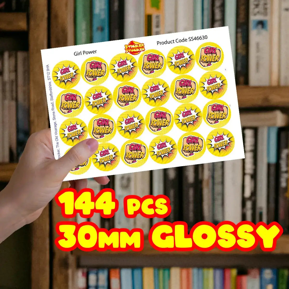 Hand holding Girl Power reward stickers sheet, 144 pcs, 30mm glossy, in front of bookshelves