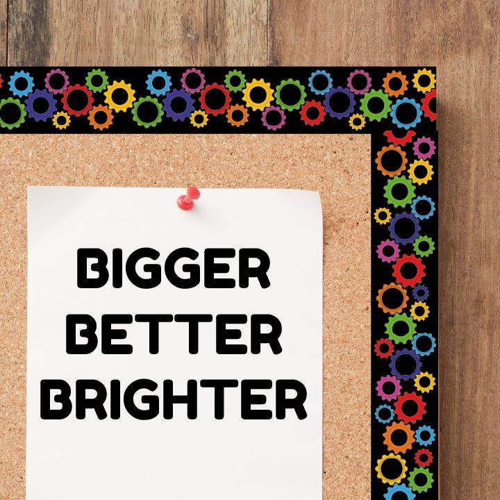Cork bulletin board with a white paper that says 'Bigger Better Brighter,' colorful gear border.
