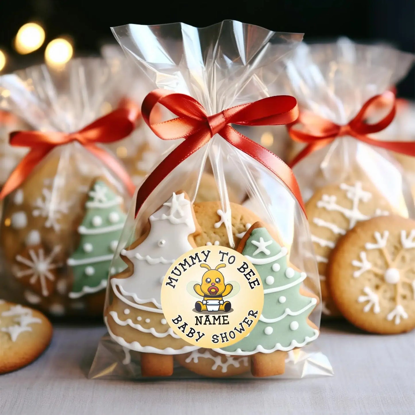 Christmas tree decorated cookies in clear gift bag with baby shower sticker, red ribbon