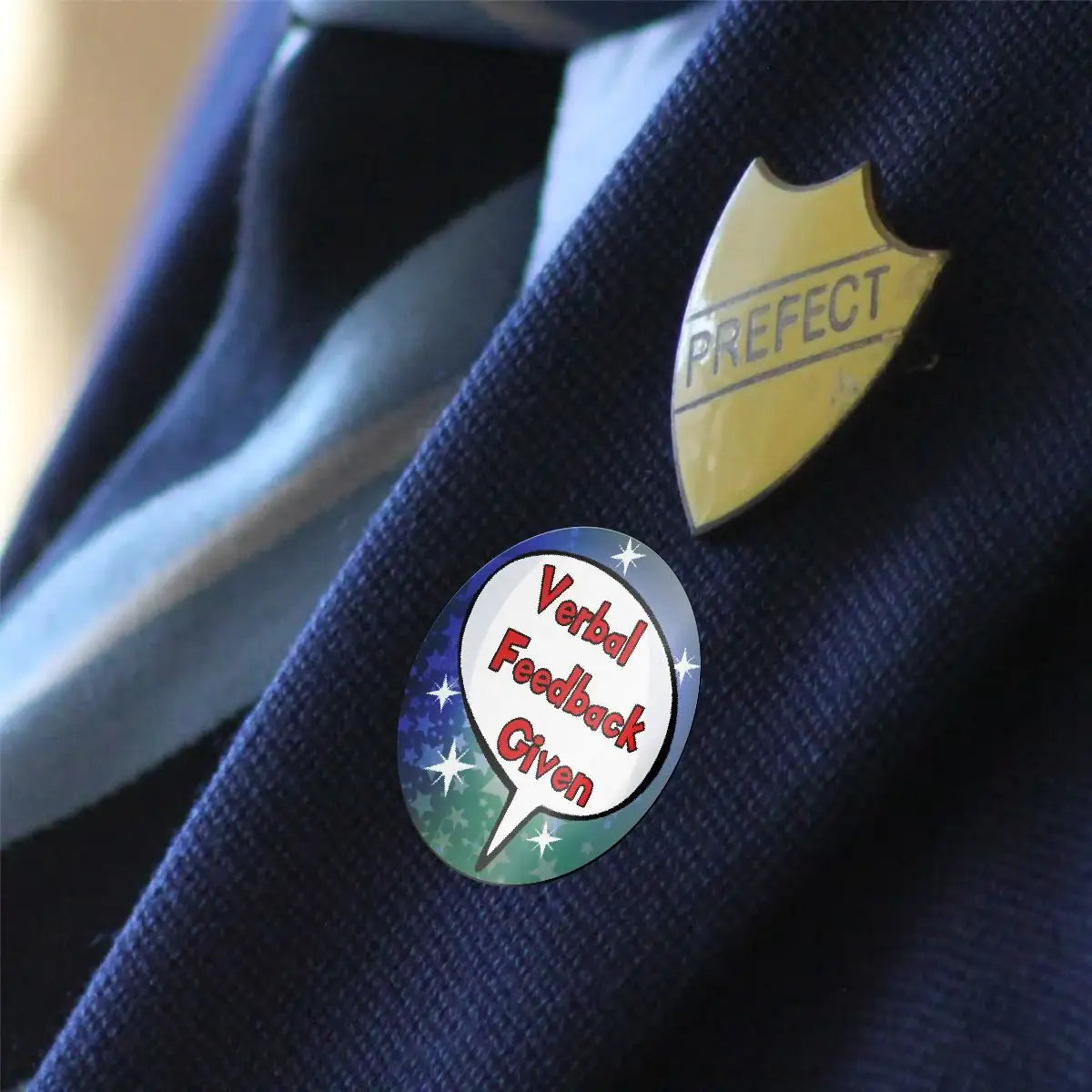 Verbal Feedback Given reward sticker and prefect badge on school uniform jacket