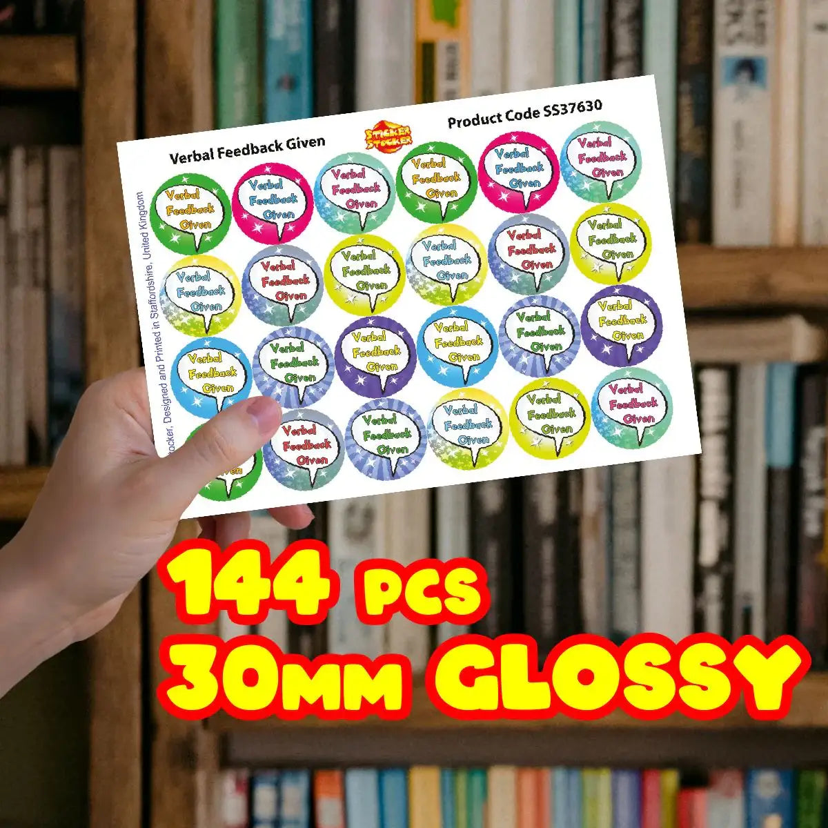 Hand holding a sheet of colorful 30mm glossy reward stickers for verbal feedback, 144 pieces