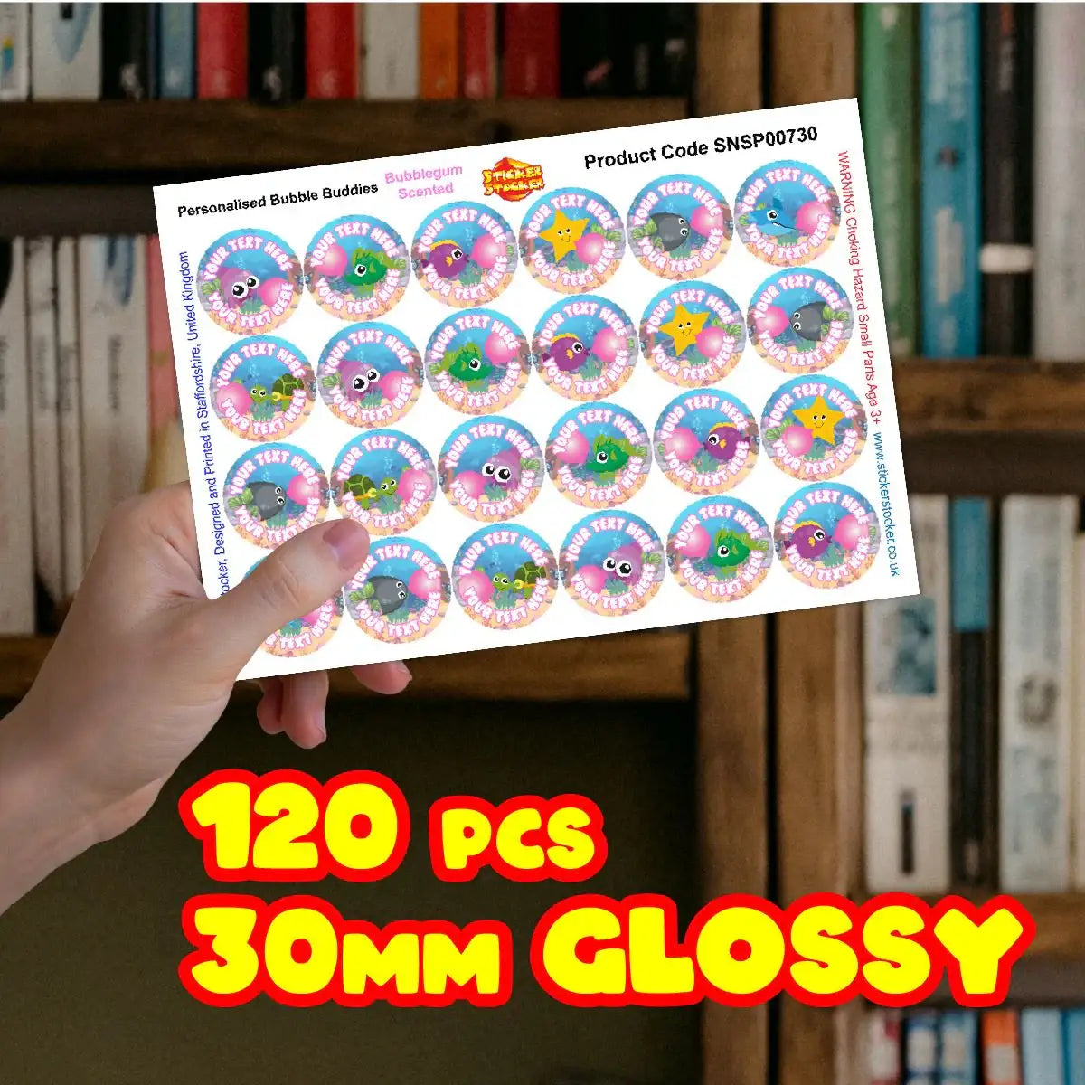 Hand holding sheet of 30mm glossy reward stickers with colorful bubblegum designs, 120 pieces