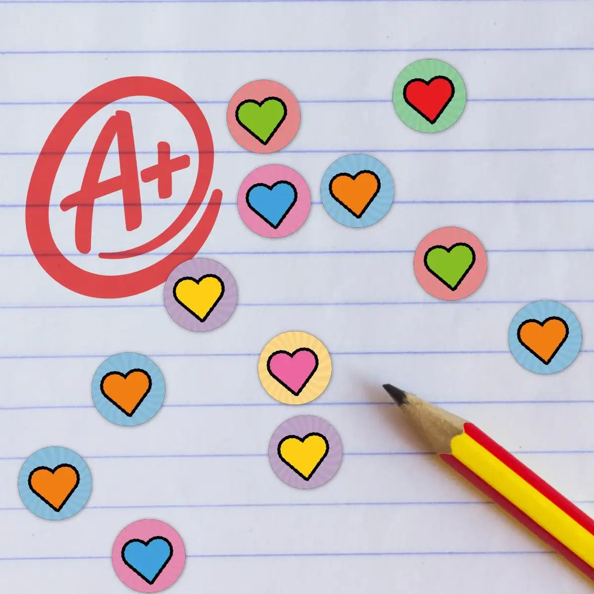 Colorful heart reward stickers, A+ grade, pencil on lined paper for classroom motivation