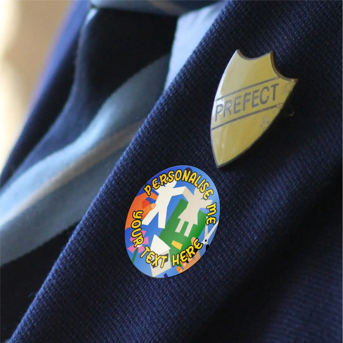 Personalised reward sticker and prefect badge on navy school blazer lapel
