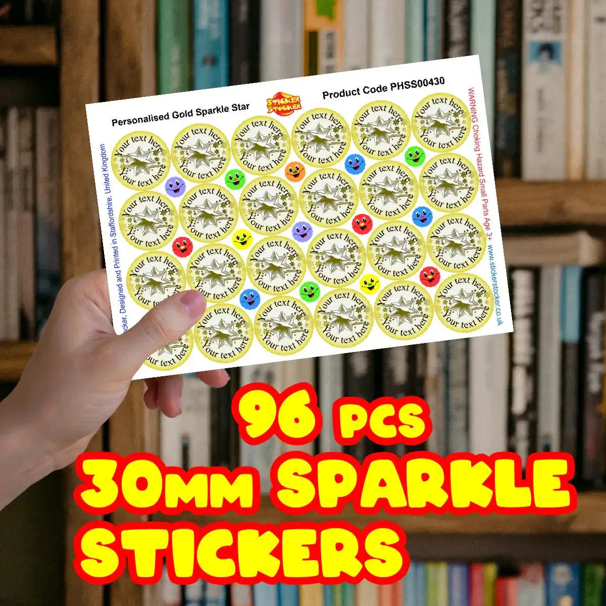 Hand holding sheet of 30mm gold sparkle star stickers with smiley face rewards, 96 pieces