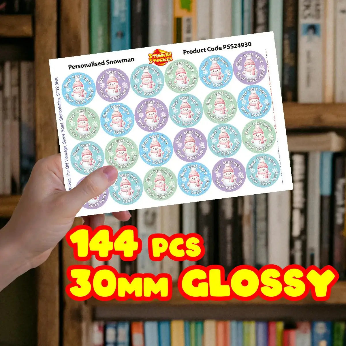 Hand holding a sheet of 30mm personalized snowman reward stickers, 144 pieces, glossy finish