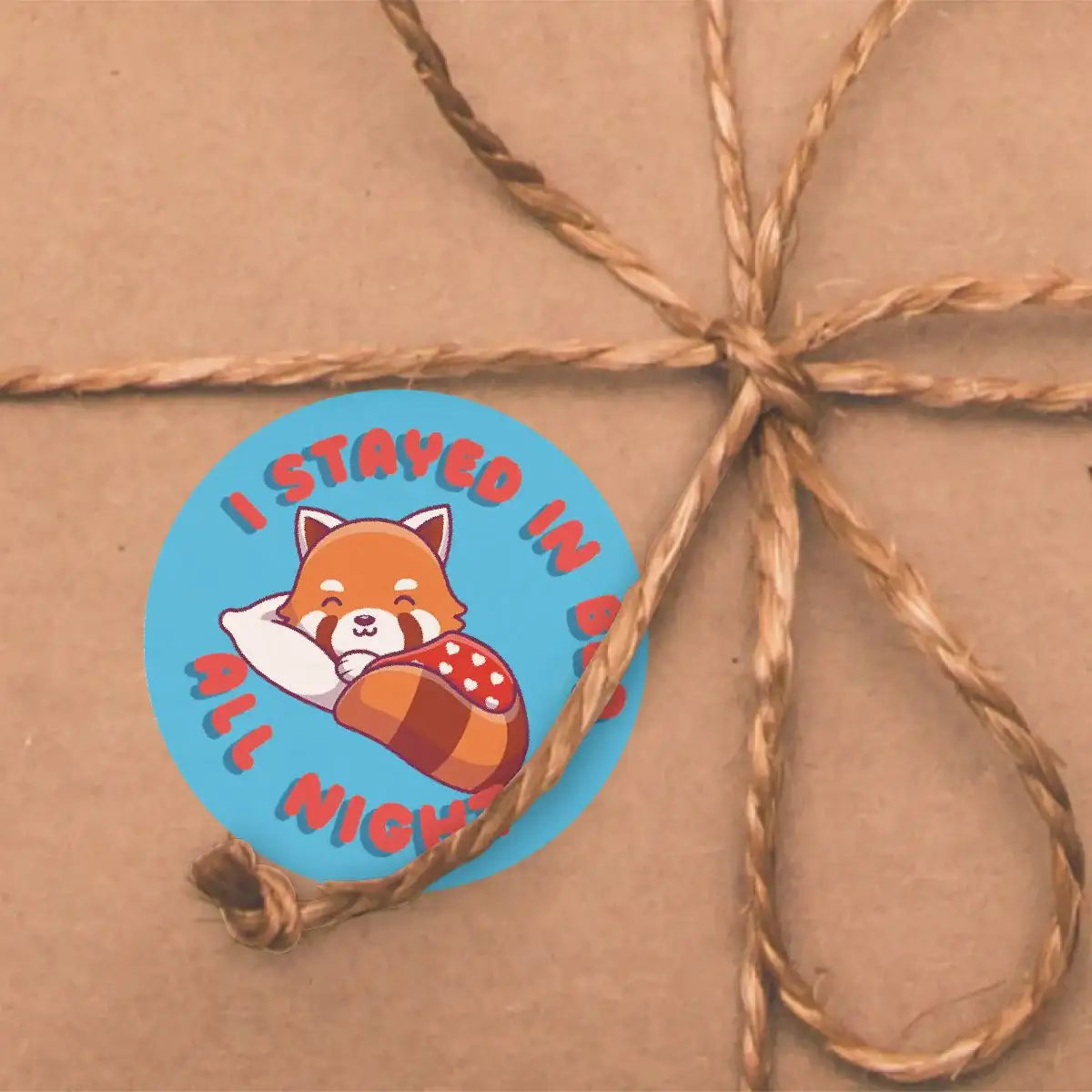 Reward sticker with cute fox sleeping, text reads 'I stayed in bed all night', on gift wrap.