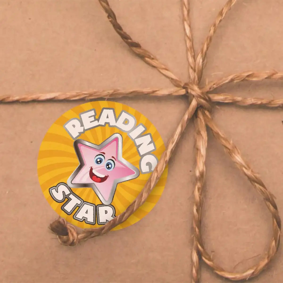Reading Star reward sticker with smiling star on brown wrapped package with twine bow
