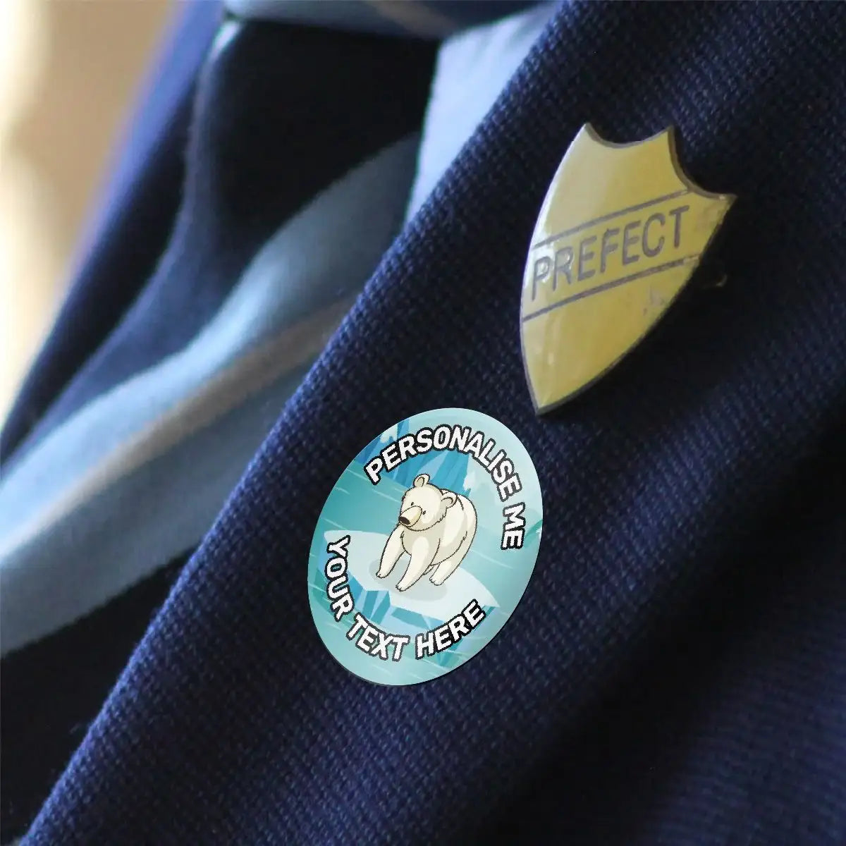 Personalised polar bear reward sticker and gold prefect badge on school blazer