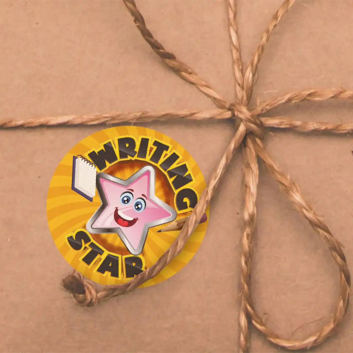 Writing Star reward sticker with a smiling pink star on brown gift wrap tied with twine