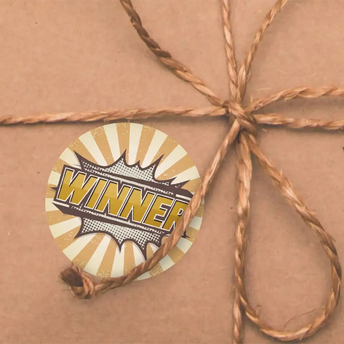 Winner reward sticker with comic style design on brown gift wrapping with twine bow