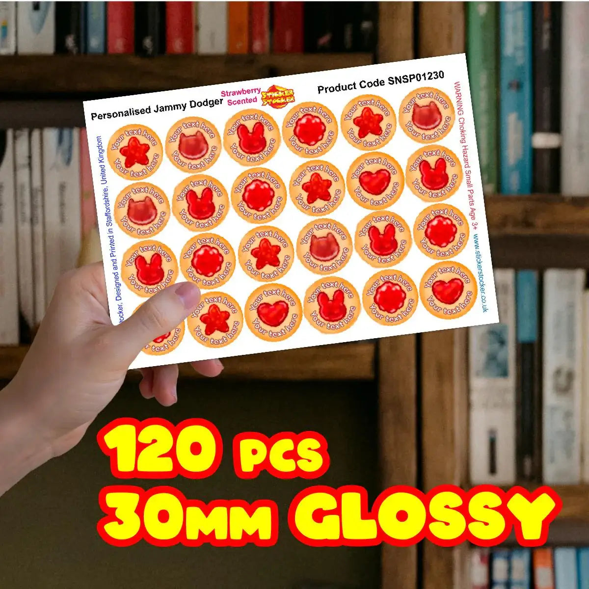 Hand holding sheet of 120 glossy 30mm strawberry scented jammy dodger reward stickers