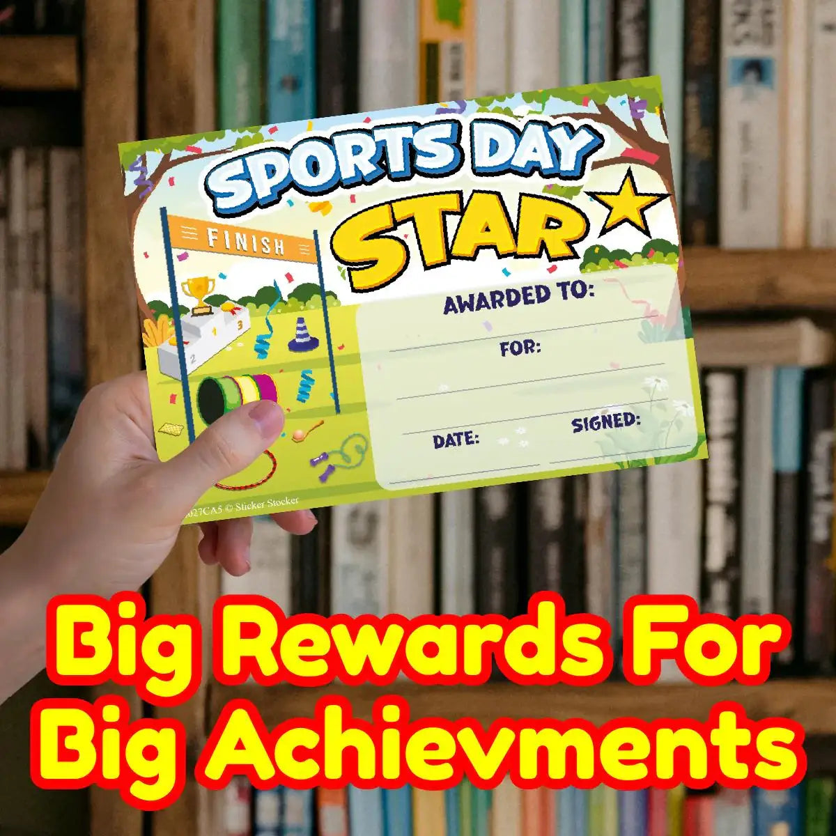 Hand holding a Sports Day Star award certificate for students, classroom bookshelf background.