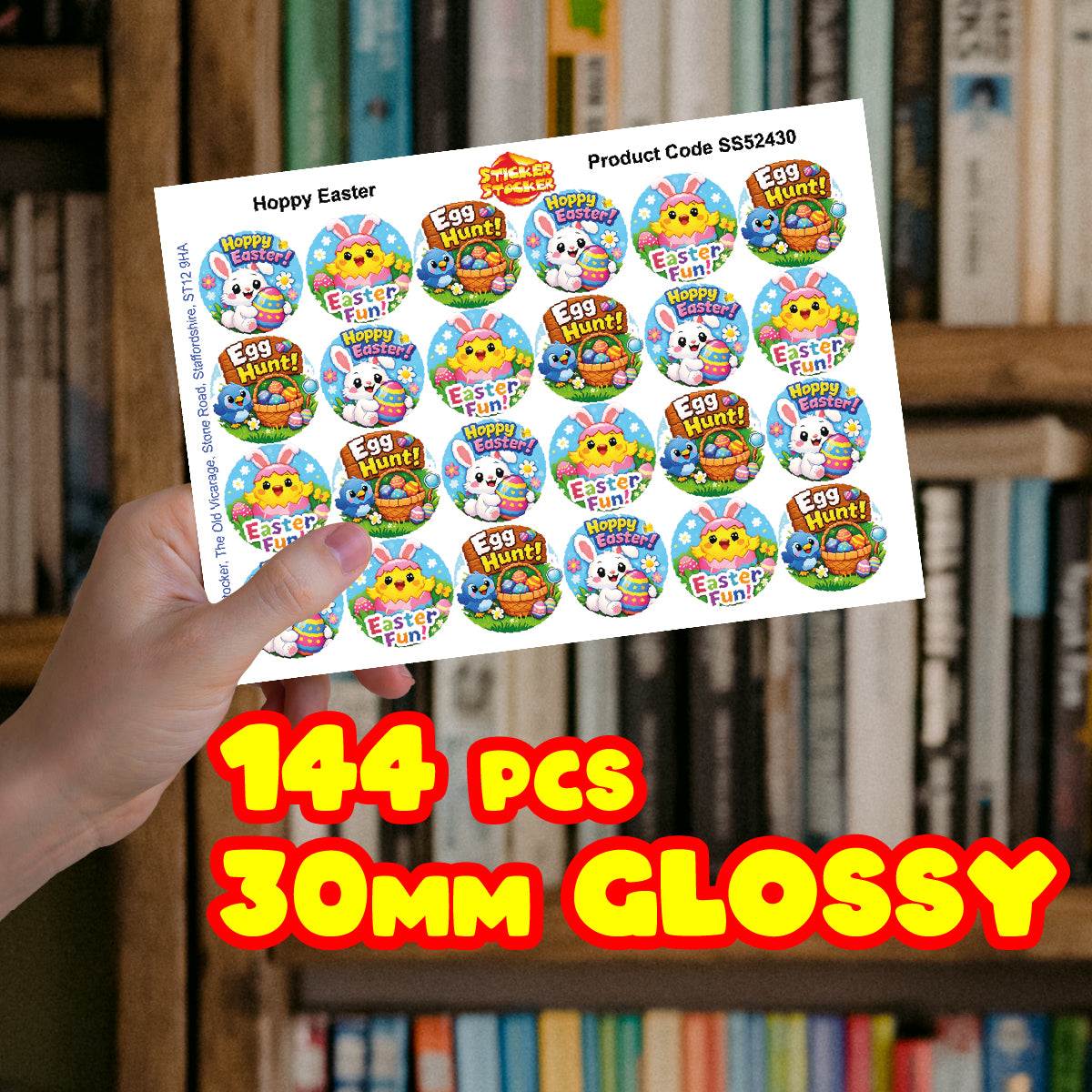 Hand holding sheet of 144 glossy 30mm Easter stickers with egg hunt and bunny designs